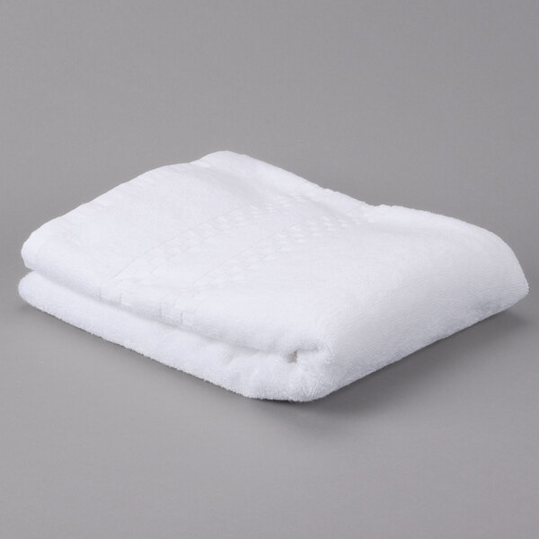 A white folded Oxford Viceroy terry towel on a gray surface.