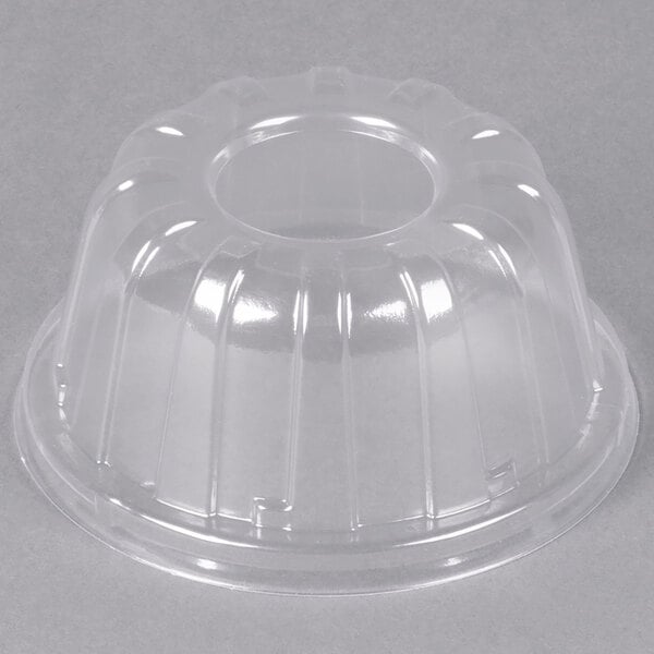 A clear plastic dome lid with a hole.