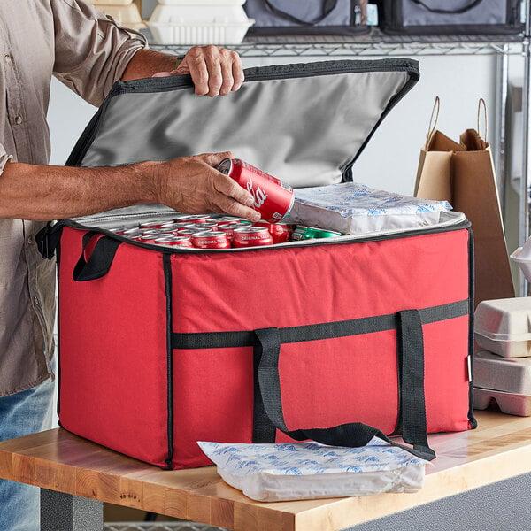 A man putting a red can into a red Choice insulated cooler bag.