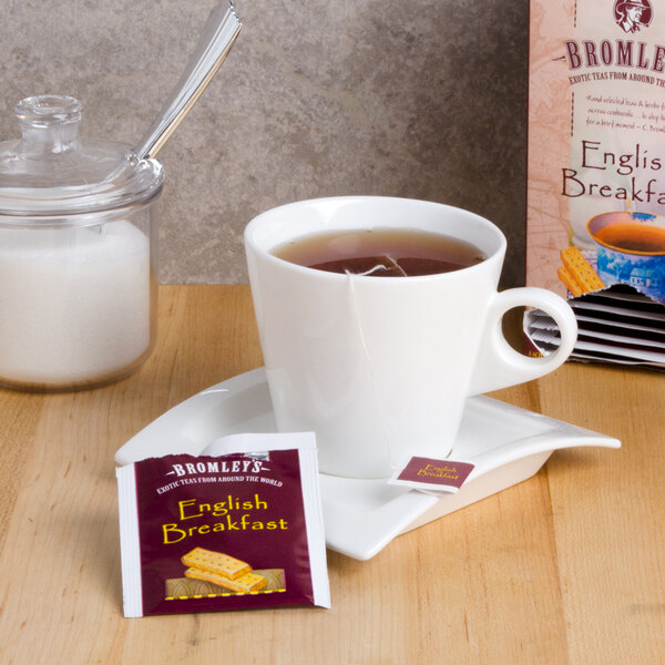 A cup of Bromley Exotic English Breakfast Tea with a tea bag in it.