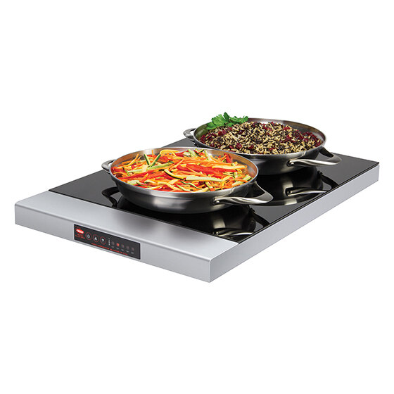 A pan with two different types of food in a Hatco heated glass shelf.