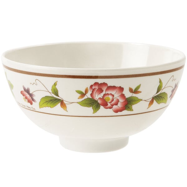 A white melamine bowl with a floral design on it.