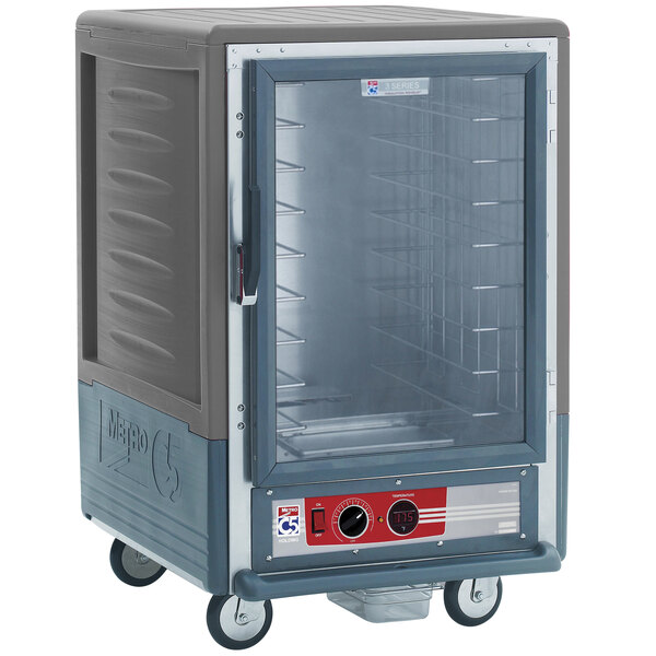 A large grey Metro heated holding cabinet with clear door and wire slides.