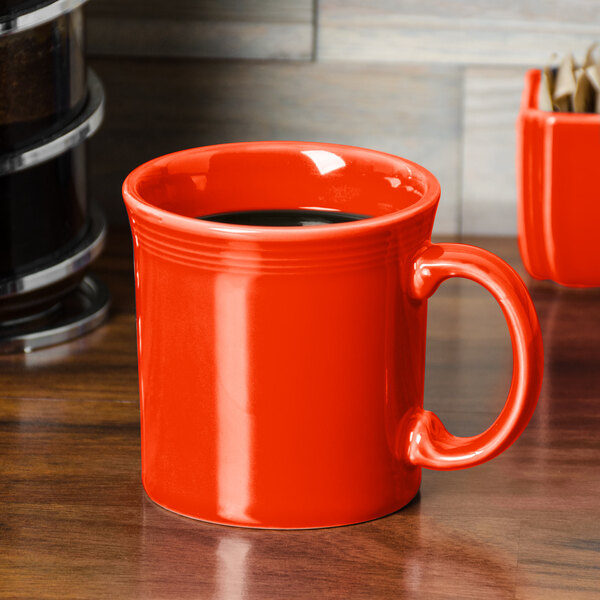 A red Fiesta china java mug on a table.