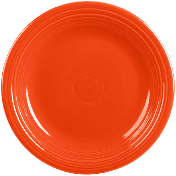 A close-up of a Fiesta® Poppy China dinner plate with a rim on it.