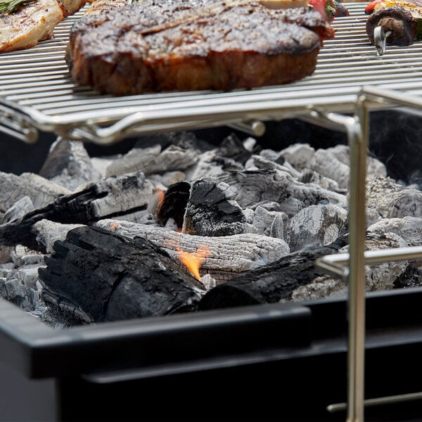 Backyard Pro Lump Charcoal grilling meat on a charcoal grill.