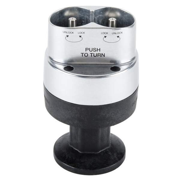 A black and silver metal base with two plugs and a push button.