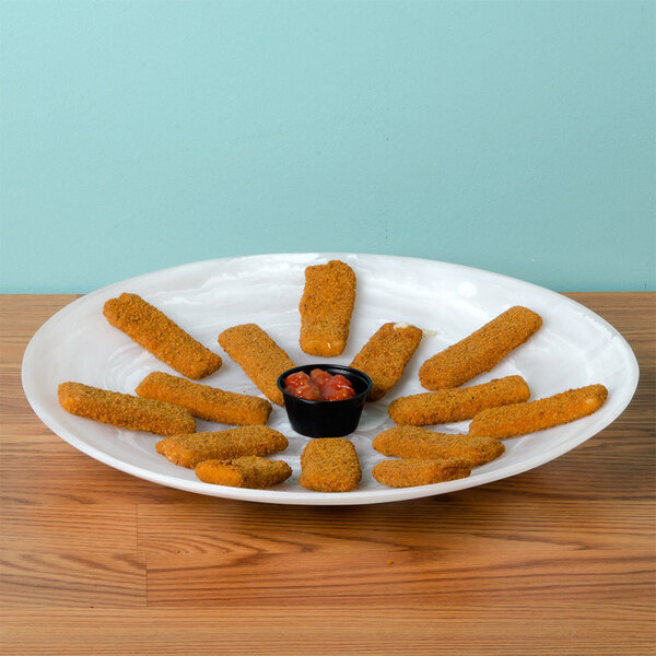 An American Metalcraft Translucence round platter with a bowl of fried chicken strips on a table.