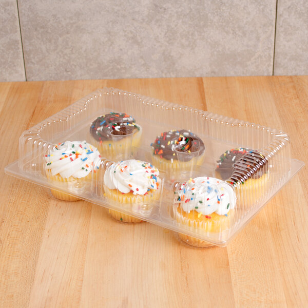 A Polar Pak plastic container holding six cupcakes with frosting and sprinkles.