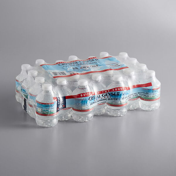 A pack of Crystal Geyser Natural Spring water bottles on a table.