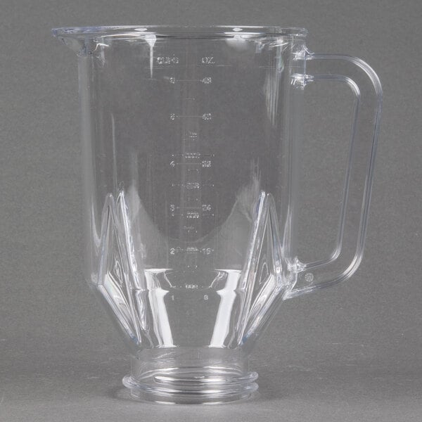 A clear plastic blender jar with a handle.