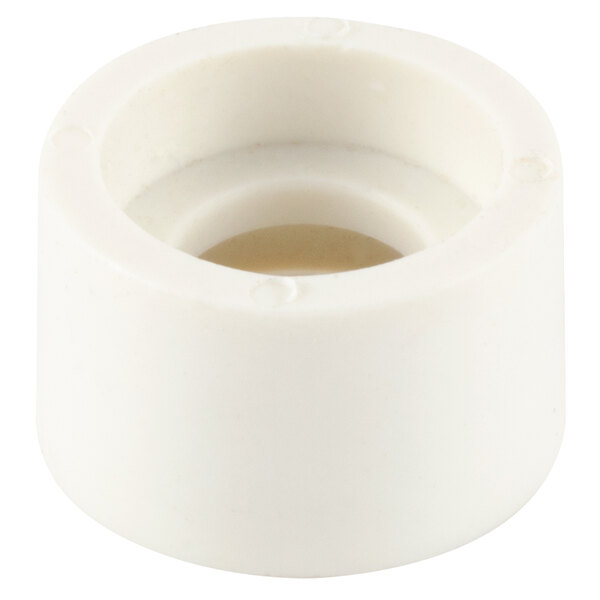 A close-up of a white plastic pipe fitting with a hole in it.
