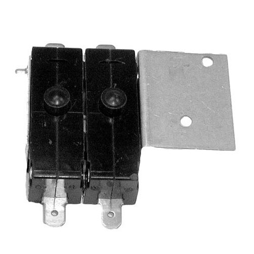 A close-up of a metal piece with two black electrical switches.