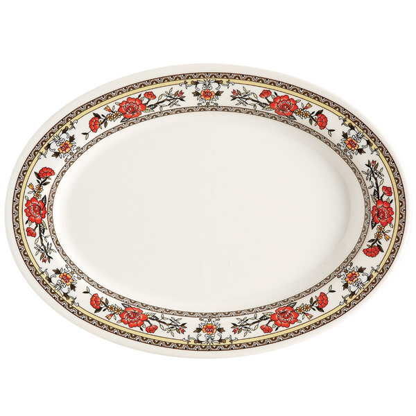 A white oval melamine platter with red flowers on it.