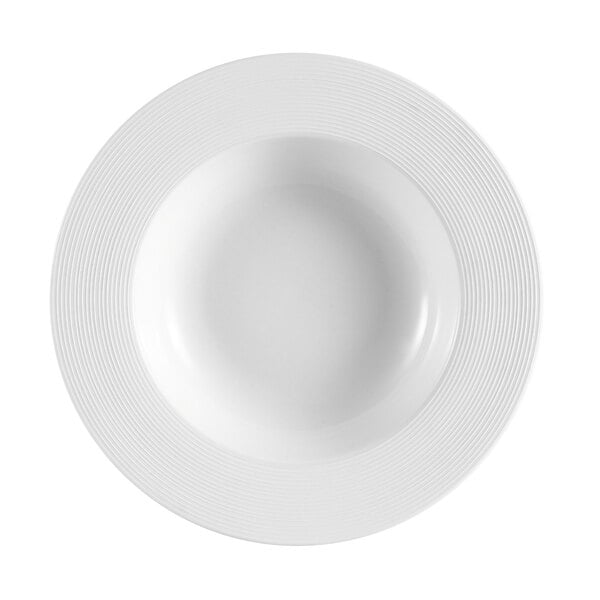 A bright white porcelain bowl with a circular design in the center.