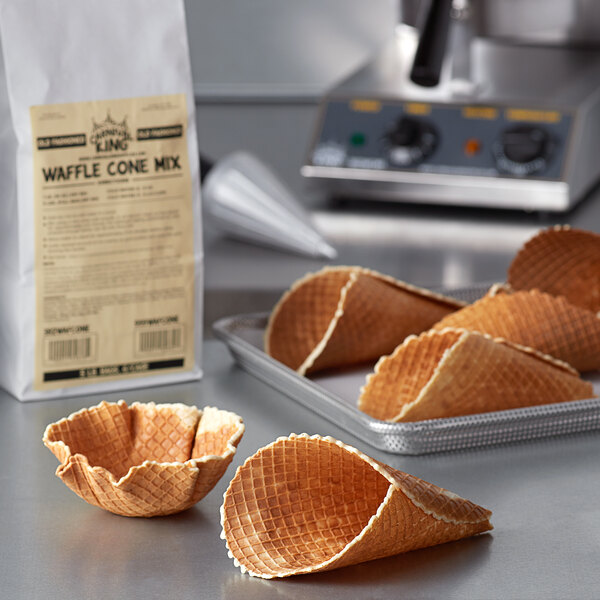 A bag of Carnival King Old Fashioned Waffle Cone Mix on a table with waffle cones.