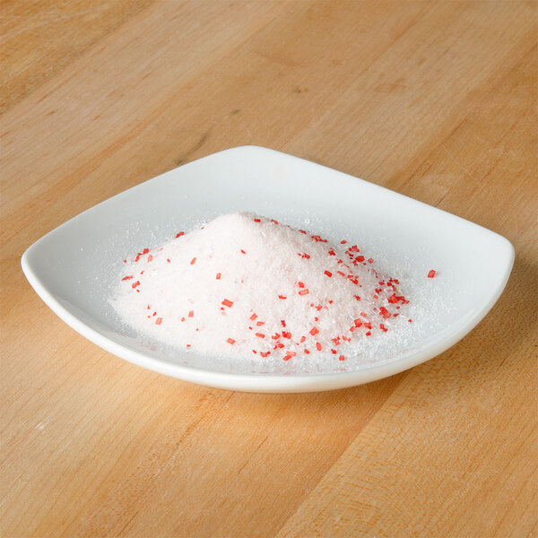 A white bowl with Rokz peppermint cocktail rimming sugar on it.