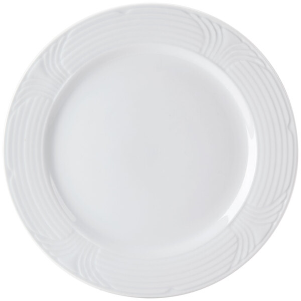 A close-up of a CAC Corona white porcelain plate with an embossed spiral design.