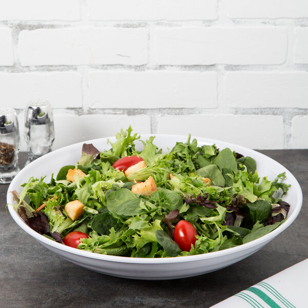 A white GET Milano melamine bowl filled with salad with tomatoes and croutons.