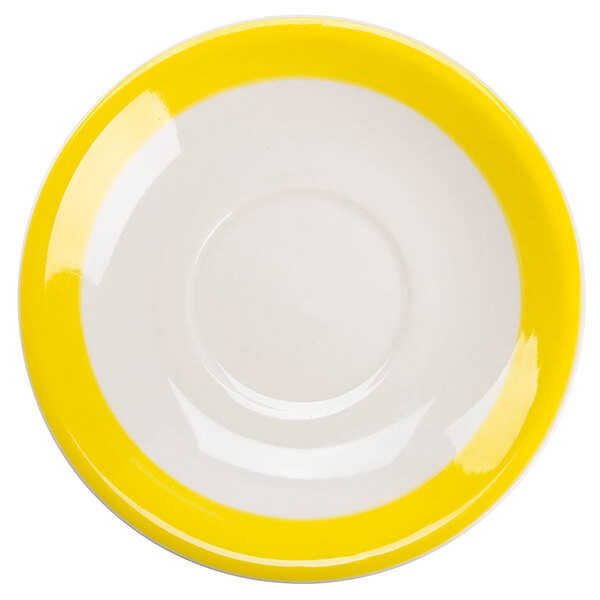 A white saucer with a yellow circular edge.