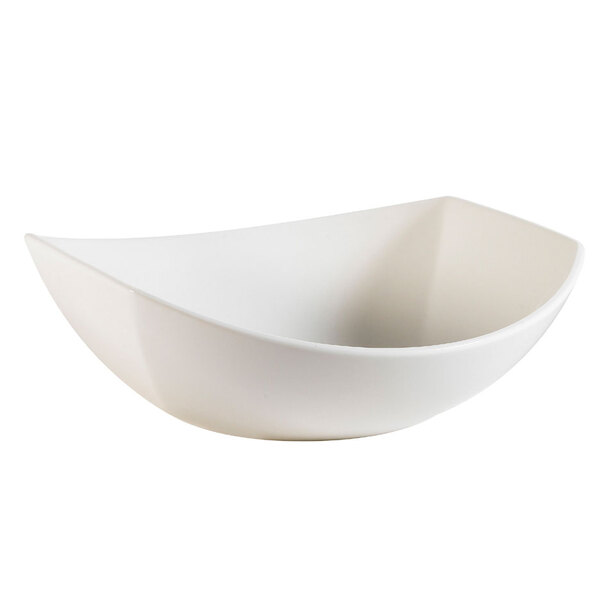 A CAC Studio bone white oval bowl with a curved edge.