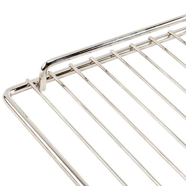A close up of a stainless steel wire rack with a handle.
