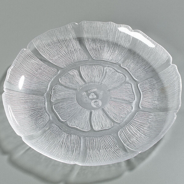 A Carlisle clear polycarbonate plate with a flower design.