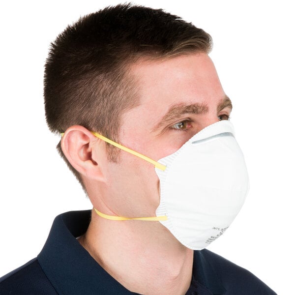 A man wearing a Cordova N-95 particulate respirator with yellow straps.