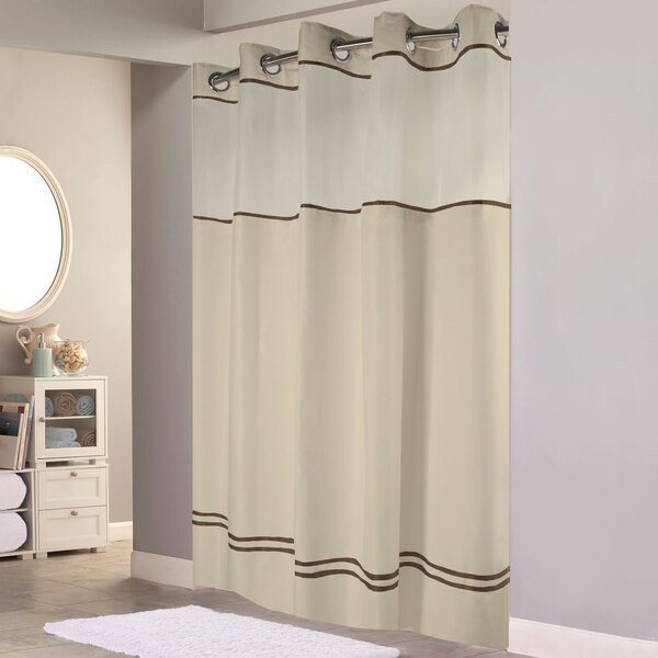 A Hookless sand shower curtain with brown stripes and a translucent window.