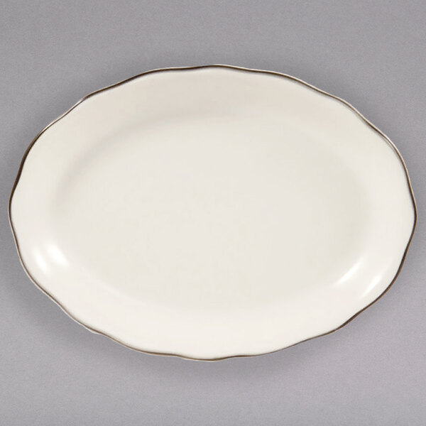 A white oval china platter with a black rim.