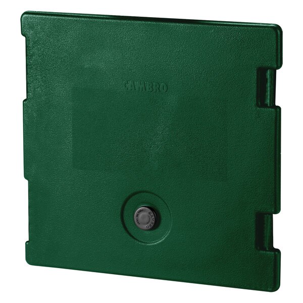 A green plastic door with a round hole and button.