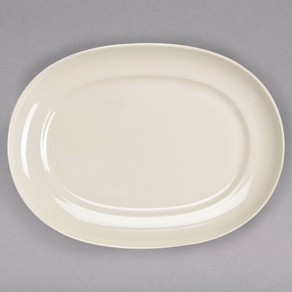 A white oval platter with a rim on a gray surface.