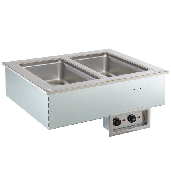 A Delfield stainless steel drop-in hot food well with two pans on a counter.