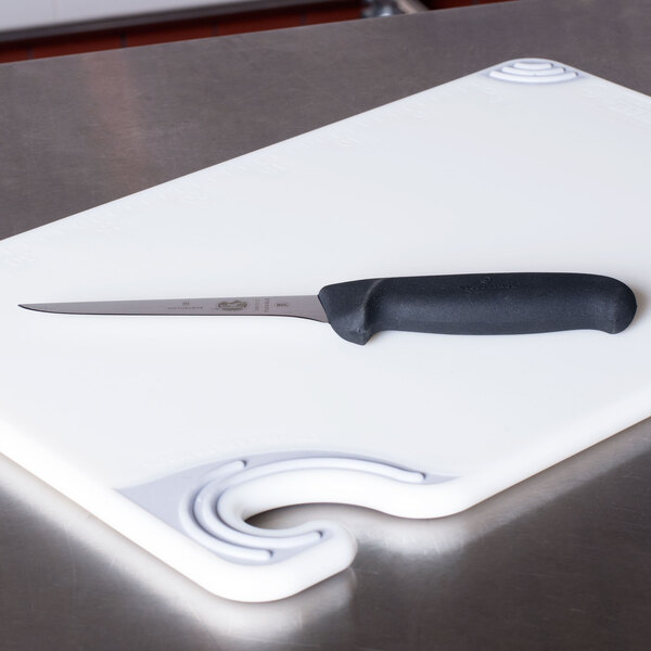 A Victorinox narrow flexible boning knife on a cutting board.