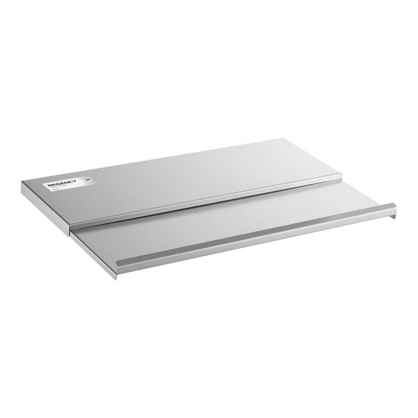 A rectangular, flat, stainless steel sliding lid with a raised edge and a small label in the corner.