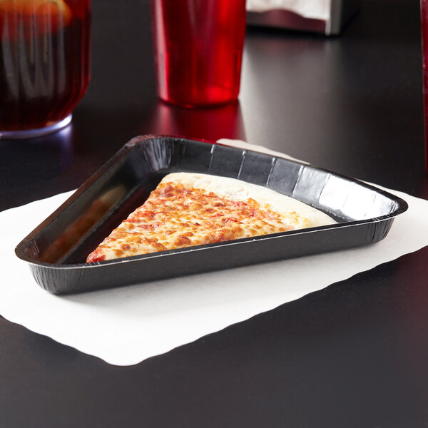 A slice of pizza in a black tray.