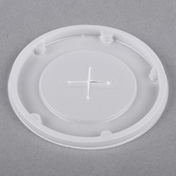 A white plastic lid with a circular hole and a straw slot.