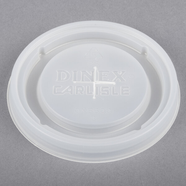 A white plastic lid with the word "Dinex" and a cross on it.