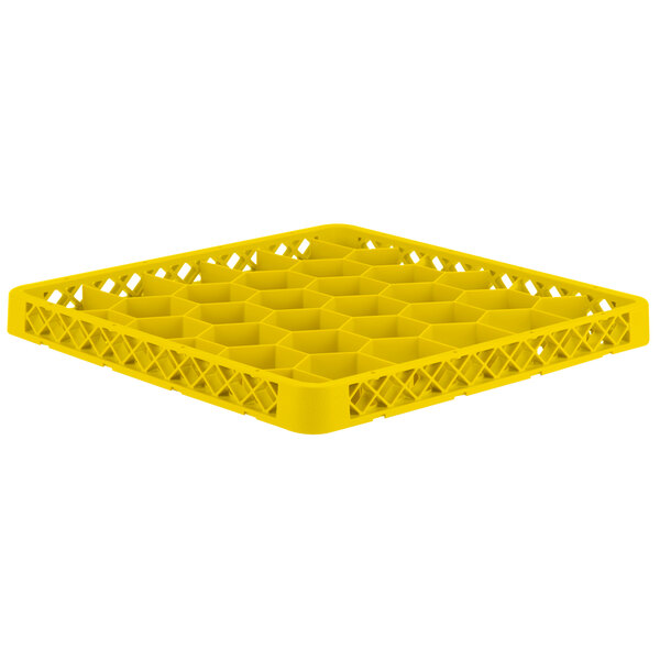 A yellow plastic Vollrath Traex glass rack extender with compartments.