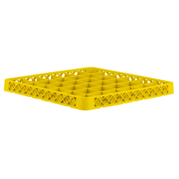 A yellow plastic Vollrath Traex glass rack extender with compartments and holes.