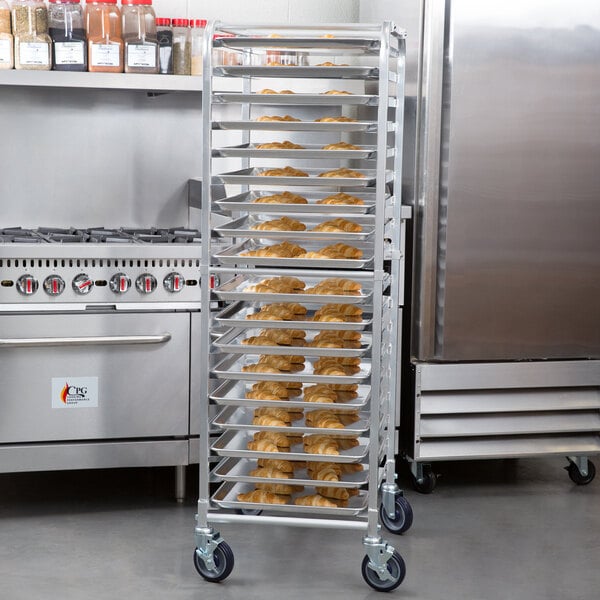 A Regency unassembled end load bun pan rack holding trays of croissants.
