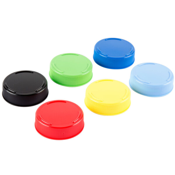 A group of Tablecraft assorted color plastic caps for squeeze bottles, including blue, green, red, and yellow.