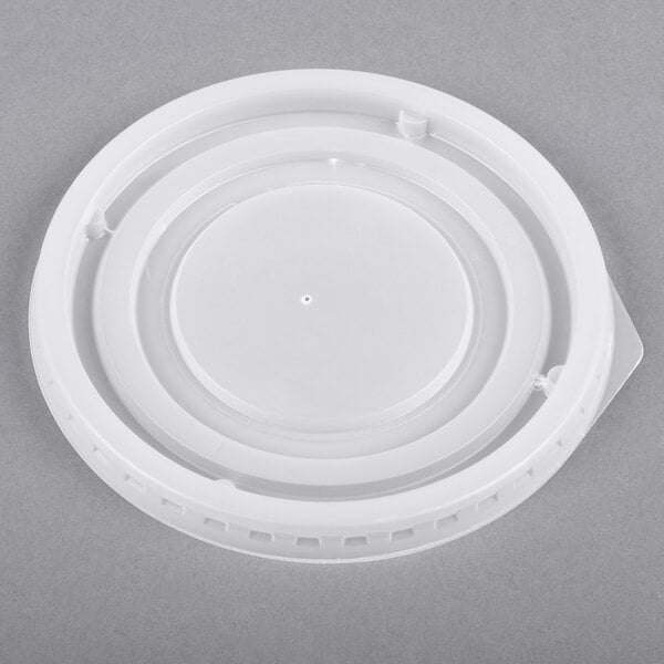 A white plastic lid with a round top and a circular rim.