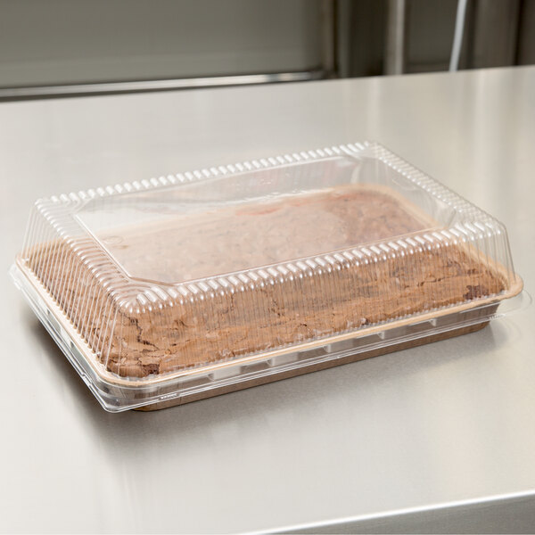 A Solut clear dome lid on a plastic container with food inside.