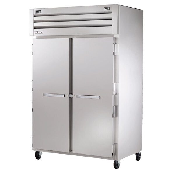 A True stainless steel refrigerator with two solid doors.