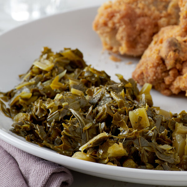 A plate of chicken with a side of Glory Chopped Collard Greens.