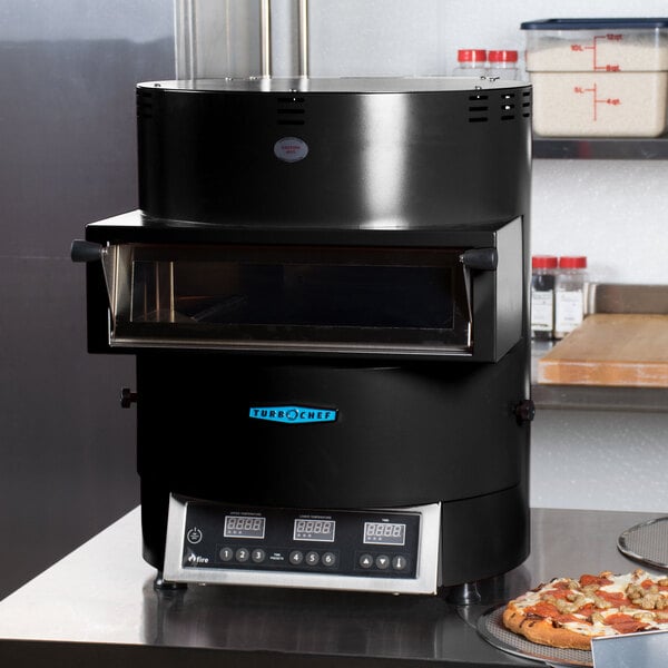 A close-up of a black TurboChef Fire electric countertop pizza oven with a glass door.