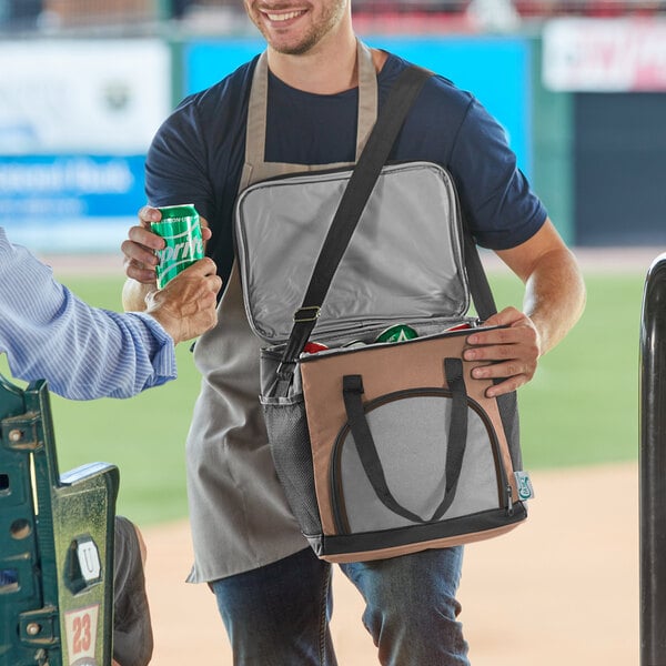 A man holding a Choice brown small insulated soft cooler bag.