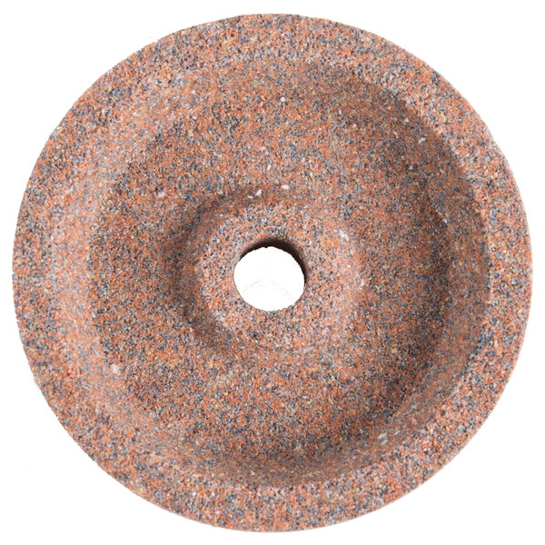 A circular stone with a hole in the middle.