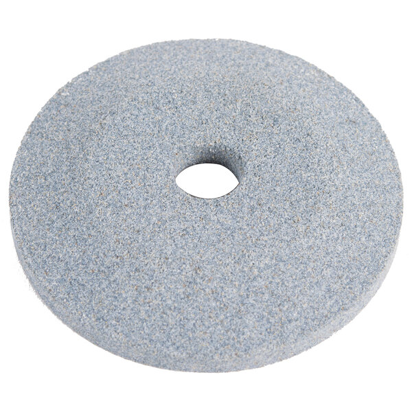 A white circular grinding wheel with a hole in the center.